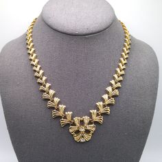 *Description: This is a beautiful gold plated linked necklace with a built in clear rhinestone pendant from the 1960s.  The fold over clasp snaps securely. This would be a great addition to your vintage jewelry collection or make a great vintage gift! *Approximate Measurements: Length - 17 1/2 Inches, Length of Pendant - 1 Inch, Weight - 2 Ounces *Condition: Very good vintage condition.  Will see signs of wear under magnification. See photos for details. *Hallmark:  Unsigned *Item # 5934 Please Elegant Gold Rhinestone Necklace For Formal Occasions, Vintage Jeweled Necklace For Anniversary, Classic Gold Necklaces With Jewels, Classic Gold Necklace With Jewels, Retro Yellow Gold Jewelry For Evening, Vintage Metal Rhinestone Necklace With Jewels, Vintage Yellow Gold Necklaces With Jewels, Vintage Gold Plated Formal Jewelry, Vintage Yellow Gold Necklace With Jewels