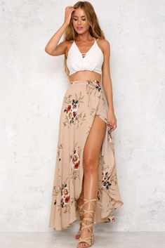 The Ivy Cottage Maxi Skirt is long and flowy, with a gorgeous floral print, a self tie and a half inner lining. Style with an off shoulder crop top and a necklace! Maxi skirt. Half lined. Cold hand wash only. Model is standard XS and is wearing XS. True to size. Slightly stretchy fabric. Cotton/polyester. Bohemian Floral Print Skirt For Brunch, Bohemian Bottoms For Summer Garden Party, Bohemian Bottoms For Garden Party In Summer, Bohemian Flowy Bottoms For Brunch, Beige Bohemian Maxi Skirt For Day Out, Bohemian Flowy Maxi Skirt For Brunch, Flowy Beige Maxi Skirt For Summer, Chic Floral Print Maxi Skirt For Beach, Beach Skirt With Floral Print And Split Shape