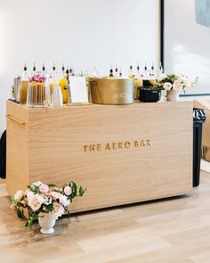 the bar is set up with flowers and champagnes on it's counter top