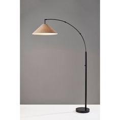 a black and white floor lamp with a wooden shade on it's side, against a gray background