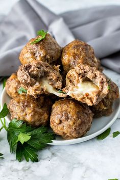 meatballs stuffed with cheese and parsley on a white plate