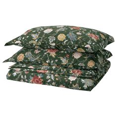 three pillows stacked on top of each other with floral print in green and pink colors