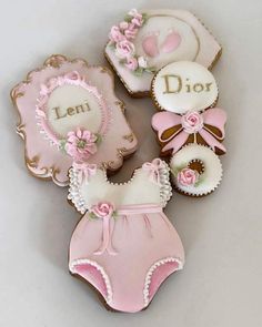 decorated cookies in the shape of baby's diapers and booties with name on them