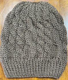 This lightweight beanie is knitted in  Double Cable Knit Slouchy Beanie style, that will help keep you warm during the chilly seasons. The fun brown color with metallic threading will add a fun pop to any outfit in your wardrobe.  This beanie is knitted with love and the hope that you or whomever you gift it to will love it for years to come.  Easy care, wash on gentle and dry on low heat or allow to air dry. Part of the proceeds from this sale will go towards helping those in need in the Pacific Northwest Communities.  Thank you for your support in advance! Fall Cable Knit Beanie One Size, Casual One Size Cable Knit Beanie, Brown Beanie For Cold Weather In Fall, Cozy Brown Beanie For Fall, Brown Hand Knitted Beanie Cap, Cable Knit Beanie One Size Fits Most, Brown Hand Knitted Hat One Size, Hand Knitted Brown Beanie, One-size Cable Knit Beanie