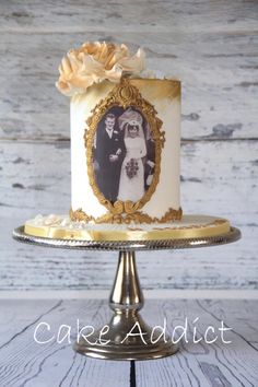 a white and gold wedding cake with an old photo on it