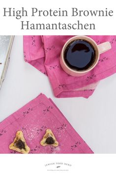 a cup of coffee sitting on top of a pink napkin next to two pieces of food