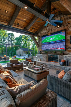 a large living room with couches and a flat screen tv mounted to the wall