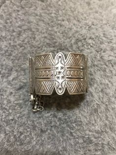 A beautiful old Berber silver bracelet from Morocco. The surface of the bangle has been finely hand-etched with a design combining lines, and the surface as well as interior have both obtained a rich patina from wear and usage. It opens and closes with a pin. Inner diameter : 5,8cm Width : 3,7cm Weight : 83,8g Bohemian Filigree Bangle Bracelet, Bohemian Bangle Bracelet With Filigree, Bohemian Filigree Cuff Bracelet, Bohemian Etched Bangle Bracelet, Bohemian Etched Sterling Silver Bracelet Gift, Engraved Bohemian Bangle Jewelry, Bohemian Antique Silver Bracelet With Intricate Design, Bohemian Silver Filigree Bracelets, Bohemian Bracelet With Intricate Design In Antique Silver