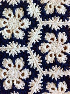 a crocheted blue and white doily with snowflakes on it's edges