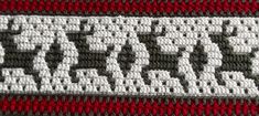 closeup of the crochet pattern on a red and gray blanket with white letters