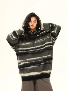 Embrace the chill with a touch of effortless edge in our Striped Oversized Drop Shoulder Fuzzy Sweater. This cozy knitwear piece features a bold striped pattern, lending a graphic punch to the fuzzy texture that promises warmth and comfort. The oversized fit with drop shoulders adds a contemporary twist to this classic silhouette, ensuring you stay both stylish and snug. Perfect for layering or as a statement piece, pair it with fitted jeans or leggings for a casual outing, or style it with tailored trousers for a relaxed yet polished look. Its adaptability makes it a go-to for various settings from a laid-back weekend to a creative workplace environment. Product specifications: Material: 100% Polyester Fit: Oversized with drop shoulders Closure: Pullover style Texture: Fuzzy with prominen Oversized Striped Cozy Sweater, Cozy Oversized Striped Sweater, Striped Sweater For Winter Loungewear, Striped Jacquard Knit Sweater For Winter, Winter Striped Jacquard Knit Sweater, Winter Jacquard Knit Striped Sweater, Fuzzy Sweater, Brown Sweater, Jumper Sweater