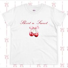 A women's tee inspired by Sabrina Carpenter's album, Short n Sweet, featuring cherries and a bow design. This tee exudes a fun and playful vibe, perfect for fans of Sabrina Carpenter or those who appreciate whimsical designs. Ideal for casual wear or as a statement piece for concerts, music festivals, or everyday outings. Product features - 100% cotton composition for comfort - Double needle sleeve and bottom hems for durability - Side seams for shape retention - Neck and shoulder tape for stabi Sabrina Carpenter Album, Fruit Graphic, Bow Women, Sweet Cherries, Fashion Top, Bow Design, Graphic Shirt, Sabrina Carpenter, Shirt Price