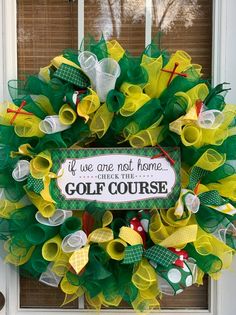 a green and yellow mesh wreath with the words golf course on it that says if we are not home, check the golf course