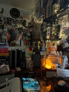 a cluttered room with many books and lights