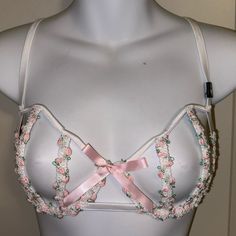 Secret Garden Collection What A Sexy Bra! Open Cage Style With Flexible Boned Rows Making Up The Cups. One Section Of Boning On The Sides, And Then The Back Is An Open Elastic Pattern. It Is Ivory On Color, With A Feminine Embroidered Floral Patterned Lace In Pink, Green And Ivory. Double Hook Back, 4 Rows For Size Adjustment. Silver Colored Hardware, Adjustable Elastic Shoulder Straps. Feminine Party Bra With Delicate Straps, Feminine Party Bra, Feminine White Bra With Delicate Straps, Feminine White Bra For Party, Spring Bra With Delicate Straps, Feminine White Party Bra, Victoria's Secret Bra With Built-in Support For Spring, Feminine Underwire Bra For Spring, Spring Feminine Underwire Bra