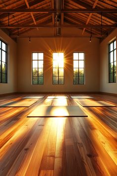 the sun shines through three windows in an empty room with wooden floors and beams of light