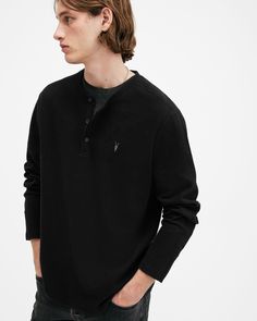 An easy essential? This is it. The Rowe is a long-sleeve henley shirt made from organic cotton with a waffle texture that's super soft to touch. Complete with flatlock stitching and our signature Ramskull embroidery, it's the perfect piece for casual days.  This henley is designed to a regular fit that is true to size Three button placket Long sleeve Waffle fabric with a soft handfeel Ramskull embroidery Flatlock stitching Allsaints Long Sleeve Fall Sweatshirt, Allsaints Cotton Long Sleeve Tops, Allsaints Long Sleeve Cotton Tops, Allsaints Cotton Tops For Fall, Allsaints Long Sleeve Tops For Spring, Allsaints Long Sleeve Tops For Fall, Allsaints Relaxed Fit Long Sleeve Tops, Allsaints Long Sleeve Relaxed Fit Tops, Long Sleeve Cotton Henley With Ribbed Cuffs