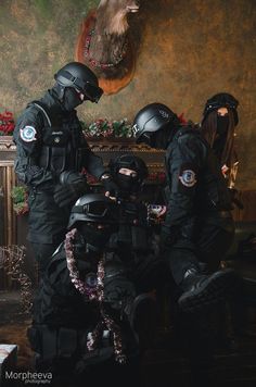 three police officers in full gear standing next to each other