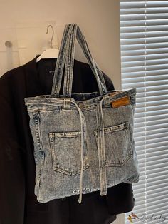 an old pair of jeans hanging on a coat rack