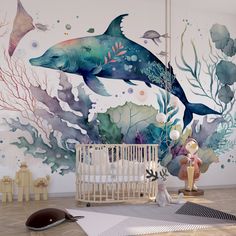 a baby's room with a dolphin mural on the wall