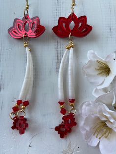 three pairs of red and white earrings with flowers