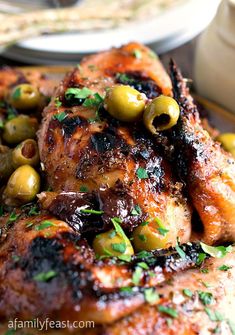 grilled chicken with olives and parsley on the side, ready to be eaten