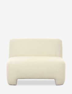 a white couch sitting on top of a wooden table