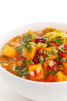 a white bowl filled with soup and vegetables