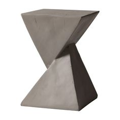 a concrete sculpture sitting on top of a white floor