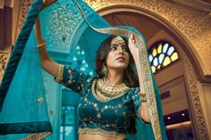 Look stylish in this teal blue 3-piece set, crafted with kumkum silk, lino silk & nylon satin, and heavy net fabric for the blouse, lehenga, and dupatta respectively. Features intricate hand work, zari & sequins embroidery, round neck, regular sleeves, and 10-meter ruffle style flair on the lehenga. The set comes with a dupatta and customizations are available - simply add your measurements during checkout. Dry clean only. No of Set - 3-piece set Color- Teal Blue Blouse Fabric - Kumkum Silk Blou Blue Color Lehenga, Traditional Dress For Women, Teal Blue Blouse, Satin Lehenga, Silk Lehenga Choli, Indian Lehenga Choli, Lehenga Choli Wedding, Choli Blouse, Stitched Lehenga