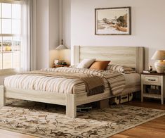 a bedroom with a bed, nightstands and rug on the wooden floor next to windows