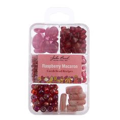 the raspberry macaron is packed in a plastic container with its contents