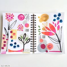 an open notebook with colorful designs on it