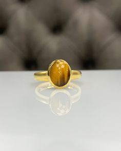 Natural Tiger Eyes Ring * Dainty Cabachon Ring * Genuine Tiger Eyes & 14K Solid Gold * Best Gift for Her/Him * Handmade Ring ◎ Details ◎ ○ Gemstone Details .Natural TIGER EYES Oval Cut 10x8 mm approx. 2.00 ct ○ Gold Details 14K Solid Gold Width of Band : 2.50 mm Weight of Ring : approx 3.80 gr Made to Order HANDMADE ITEM ○ Upgrade to Solid 18K Gold, please click the link below: https://www.etsy.com/listing/962826004 For more CABACHON BEZEL rings : http://etsy.me/37fvI60 All of our jewellerie Timeless Gold Cluster Ring With Gemstone, Gift Yellow Gold Cabochon Signet Ring, Gold Oval Birthstone Ring With Polished Finish, Handmade 14k Gold Oval Cabochon Jewelry, Gold Signet Ring With Cabochon Gift, Gold Oval Cabochon Signet Ring As Gift, Gold Oval Cabochon Signet Ring For Gift, Handmade 14k Gold Oval Rings, Gold Cabochon Signet Ring Gift