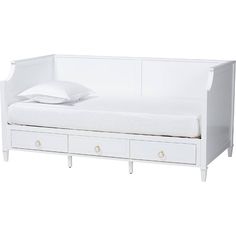 a white daybed with drawers underneath it and a pillow on the bottom shelf next to it