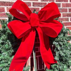 a wreath with a large red bow on it