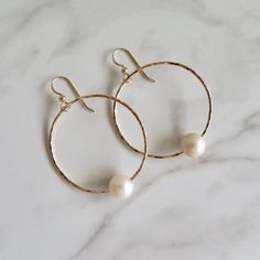 Gold Hoop Pearl Earrings~ These elegant gold hoop earrings with a freshwater white pearl will look great for any occasion. Hammered and polished to a beautiful shine. Hoops are approx. 1.5" Model wearing similar design~ https://www.etsy.com/listing/111095394/white-pearl-earrings-gold-hammered-hoops?ref=shop_home_active_22 Shop~ http://www.etsy.com/shop/HanaMauiCreations?ref=pr_shop_more International buyers please read our shipping policies before ordering~ POLICIES~ https://www.etsy.com/shop/Ha Handmade Yellow Gold Pearl Hoop Earrings, Elegant Handmade Pearl Hoop Earrings, Handmade Pearl Yellow Gold Hoop Earrings, 14k Gold-filled Small Hoop Pearl Earrings For Wedding, Elegant 14k Gold-filled Pearl White Pearl Earrings, Hammered Hoop Earrings, White Pearl Earring, Victorian Gold, Gold Pearl Earrings