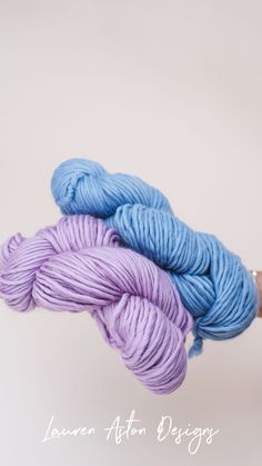 two skeins of blue and purple yarn on top of each other in front of a white background