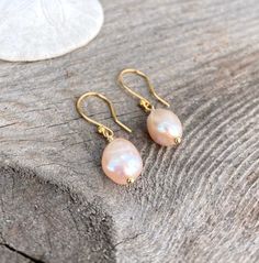 Pearl drop earring Pearl earring dangle Pearl dangle earring Teardrop peach pearl earring drop earring bridal Pearl bridal earring Gold. Genuine freshwater barque pearl 8-12mm pink/peach pearl with gold, silver, or rose gold options. Simple, Dainty and Elegant Raw Natural Stone for everyday wear. I usually wear it with a matching necklace. Simple yet elegant especially the shine and color are so gorgeous.The picture does not do it justice it and is much prettier in person. Perfect for birthday, Pearl Charm Teardrop Earrings As Gift, Pearl Charm Drop Earrings As Gift, Pear Shaped Teardrop Earrings With Pearl Charm As Gift, Pink Teardrop Pearl Drop Earrings, Pink Pearl Drop Teardrop Earrings, Pink Teardrop Pearl Earrings, Pearl Teardrop Earrings With Ear Wire For Gift, Gift Pearl Teardrop Earrings With Pearl Charm, Teardrop Pearl Charm Earrings As A Gift