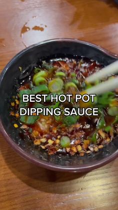 chopsticks are being used to stir food in a bowl with the words best hot pot dipping sauce