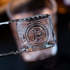 the letter p is etched into an ice cube