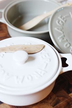 a wooden spoon sitting on top of a white casserole