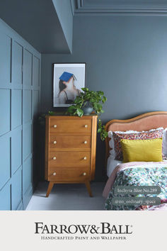 a bedroom with blue walls and furniture in it