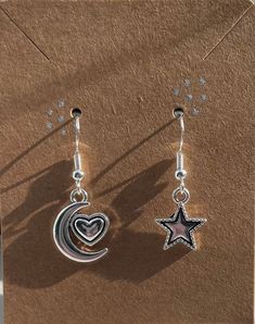 These cute and affordable star and moon earrings are great with any outfit. Made of sterling silver. Trendy Silver Star Earrings, Cute Star Charm Dangle Earrings, Cute Dangle Earrings With Star Charm, Trendy Dangle Earrings With Moon Charm, Moon Charm Star Earrings As Gift, Moon Charm Star-shaped Earrings For Gifts, Star-shaped Moon Charm Earrings For Gift, Moon Charm Star Earrings For Gift, Cute Dangle Jewelry With Star Charm