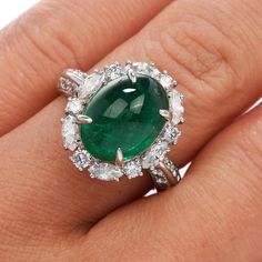 This exquisite GIA Natural Emerald & Diamond Cocktail Ring is expertly crafted in solid platinum with a total weight of 9.54 grams. The emerald with a weight of approx. 5.17 carats are surrounded by (6) round cut and (6) marquise cut genuine natural diamonds, (12) round-cut genuine natural diamonds placed on either side of the ring. All G-H color, and VS clarity forming a dazzling oval halo, The top of this piece measures 17 mm x 22 mm, 10 mm (height) currently US ring size 4.75 and sizable. Luxury Oval Platinum Gemstones, Green Oval Emerald Ring In Platinum, Luxury Oval Emerald Gemstones, Luxury Oval Cabochon Emerald Ring, Exquisite Oval Platinum Gemstones, Luxury Oval Emerald Birthstone Ring, Luxury Green Oval Gemstones, Fine Jewelry Platinum Emerald Ring With Polished Finish, Luxury Emerald Ring With Oval Cabochon