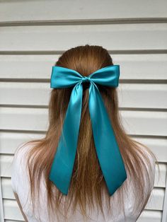 This large turquoise coquette style satin hair bow is trending right now and is so fashionable! Bow is handmade using smooth turquoise satin ribbon hand tied into a lovely bow shape and then secured onto a French Barrette with a coordinating center.  Bow is made using 2-inch, double-faced silky satin ribbon, and is approximately 6 inches in width, and the tails are approximately 10 inches long from the bow center to the tip. French barrette is 3 inches long. Bow is made for teens and adults. Model wearing bow is 16 years old. As always, if you are looking for a particular color or size of this type of bow, please message me and I can set up a custom listing.  Check out other hair bows, including velvet hair bows on my site! Find me on social media: Instagram: summer.girls.bowtique Facebook Satin Hair Bow, Types Of Bows, Coquette Bows, Bow Coquette, Teal Hair, Velvet Hair, Hair Ribbon, Handmade Hair Accessories, French Barrette