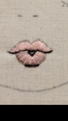 a close up of a pink lip on a piece of cloth