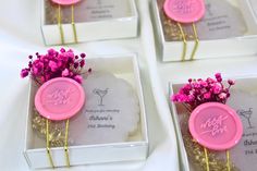 pink flowers are placed in small square boxes