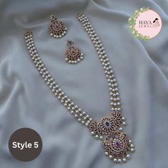 Embrace the timeless elegance of South Indian tradition with this stunning gold-plated haram necklace and earrings set. This exquisite piece features an intricate design adorned with sparkling CZ stones and delicate pearls, reminiscent of the grandeur of ancient temples. The long, layered necklace cascades down your chest, drawing attention to your neckline with its captivating beauty. Crafted with meticulous attention to detail, this set is perfect for: Bridal wear: Add an air of timeless sophistication to your wedding look with this breathtakingly beautiful set. Party wear: Make a statement at any special occasion with this eye-catching piece that is sure to turn heads. Cultural events: Immerse yourself in the rich heritage of South India with this authentic and elegant jewelry set. Feat Gold Perle Necklace, Pearl Necklace Set Indian, Gold Pearl Jewelry Necklace, Pearls Jewelry Indian, Diamond Necklace Set Bridal, Bridal Diamond Necklace Design, Long Necklace Designs, Pearl Haram, Chest Drawing