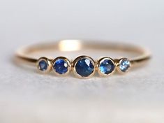 Blue sapphire ring, Blue sapphire stacking ring, dainty ring, stacking ring, stackable ring, blue sapphire ring, Sapphire ringAvailable in 9k/14k/18k yellow, rose or white gold.Same design can be made also with other custom gemstones per request. Product details:- Solid gold- approx 2.5, 2, 1.5 mm sapphire round- Band size is 1.2mmRing size - US 3 to US 9 (for smaller or larger ring size, please contact)Please select your size at the drop down menu. Service Available- Customization Available wit Sapphire Stacking Rings, Adjustable Blue Sapphire Ring Fine Jewelry, Blue Sapphire Stackable Rings For Promise, Adjustable Stackable Blue Sapphire Ring, Blue Round Band Jewelry Gift, Adjustable Blue Stackable Rings, Fine Jewelry, Blue Adjustable Stackable Rings, Fine Jewelry, Blue Adjustable Stackable Fine Jewelry Rings, Blue Adjustable Stackable Fine Rings